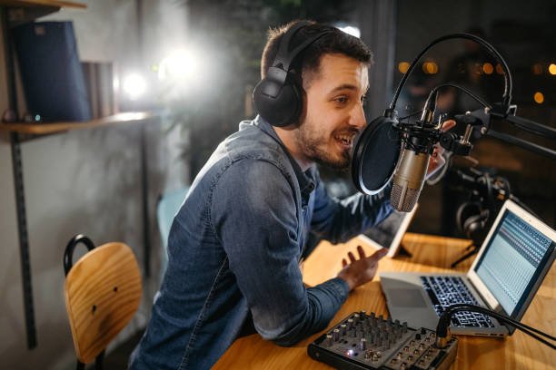 Photo of young man recording a podcast in a studio